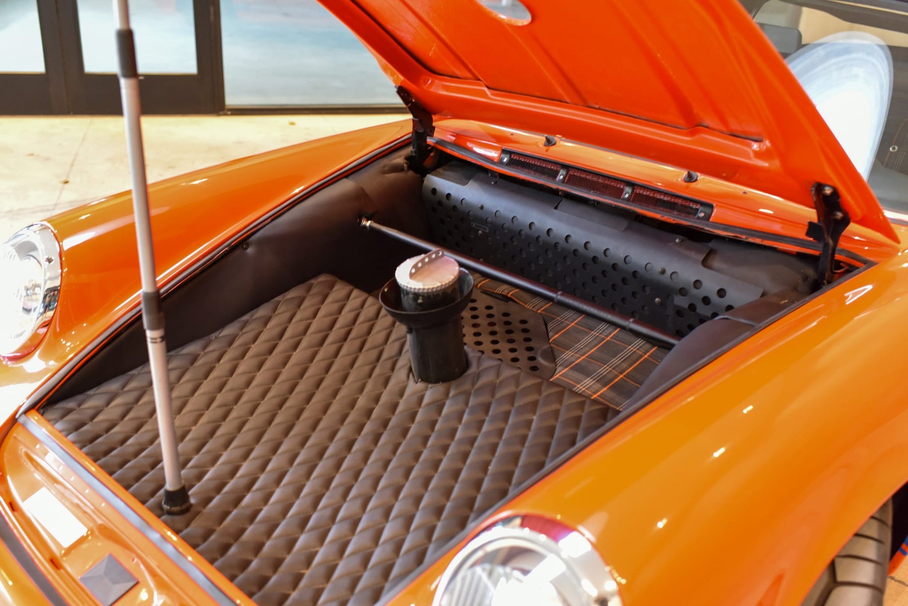 Center-fill tank and quilted front-trunk lining